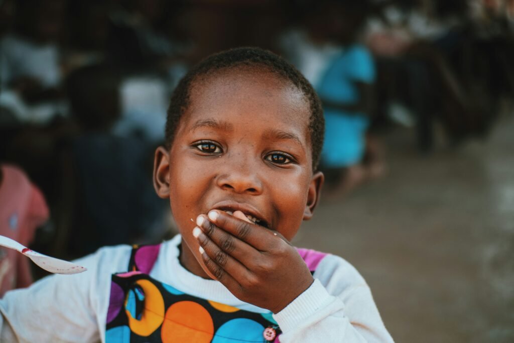 Close-up of a young child with a hand near the mouth, feeding and swallowing therapy