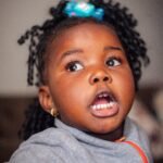 Young child during a hearing and speech assessment in Kampala